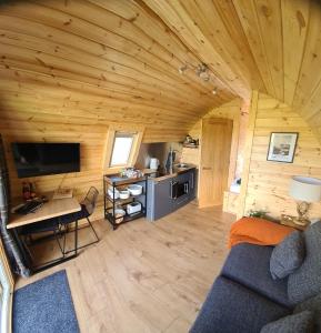 a living room with a couch and a table in a cabin at deer green place in Kinloch