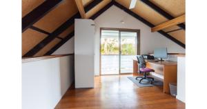 an attic office with a desk and a computer at The Lake House - Cabarita Beach in Cabarita Beach