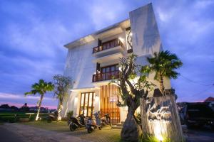 a building with motorcycles parked in front of it at The Kd Suites & Coffee Shop in Munggu