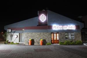 ein Gebäude mit einem Schild an der Seite bei Nacht in der Unterkunft Platinum Hotel in Gaborone