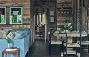 a living room with a blue couch and a table at Wildhive Callow Hall in Ashbourne