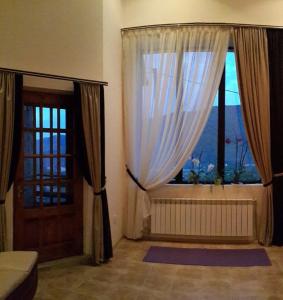 a room with a door and a window with curtains at Panorama in Yaremche