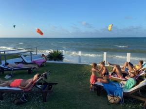 a group of people sitting on chairs on the beach at WegoKite Stars in Taíba