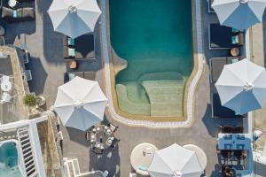 an overhead view of a swimming pool with umbrellas at Mykonos Princess Hotel in Agios Stefanos