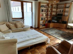 a living room with a couch and a tv at Gasthof zur Post in Schonstett