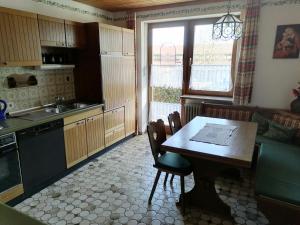 uma cozinha com mesa e cadeiras e uma sala de jantar em Gasthof zur Post em Schonstett