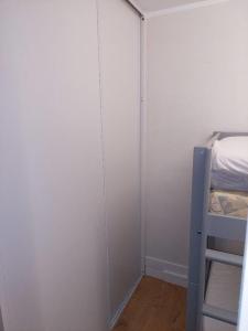 a small room with a bed and a closet at Studio Cabine Sète Corniche Vue Mer in Sète