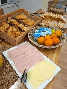 a table topped with cheese and bread and other foods at Hotel Posada del Mar in Suances