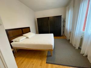 a bedroom with a bed and a black door at Ca' Liberty in Venice-Lido