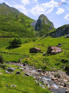 Una frondosa colina verde con casas y un río en Casa Cuevas, en Cuevas