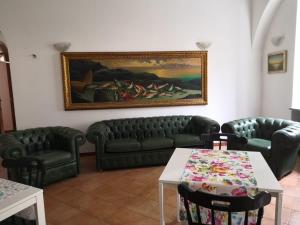 a living room with couches and a painting on the wall at la vecchia locanda in Vietri sul Mare