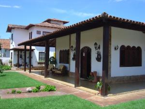 ein Haus mit einer Pergola im Hof in der Unterkunft Rey das Ostras Pousada in Rio das Ostras