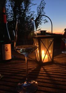 a glass of wine sitting on a table with a candle at Secret Hideaway with picturesque Sundown Views in Traben-Trarbach