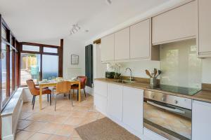 a kitchen with a table and a dining room at Badger Cottage in Parkend