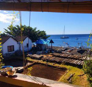 a view of the ocean from a house at Pelangi Beach Homestay in Amed