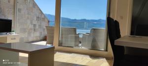 an office with a view of a balcony with chairs at The Old Town Viewpoint Apartments in Budva