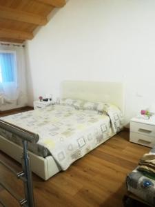 1 cama grande en un dormitorio con suelo de madera en La casa di Alice en Venecia
