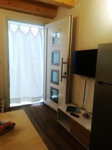 a living room with a large window and a television at La casa di Alice in Venice