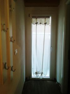 a window with a white curtain in a room at La casa di Alice in Venice