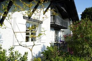 - un bâtiment blanc avec un balcon et des plantes dans l'établissement Bleuvelours, à Andernos-les-Bains