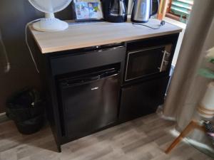 a kitchen with a black dishwasher and a counter top at Ellivuori, Ellin Pooli2 in Sastamala
