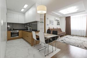 a kitchen and living room with a table and chairs at Highvill park apart in Astana