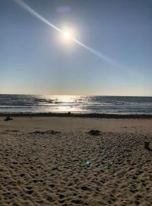 a beach with the sun rising over the ocean at La casa di Alice in Venice