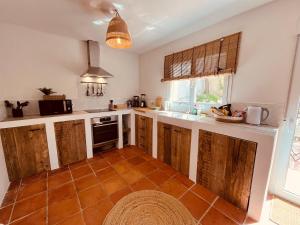 a kitchen with wooden cabinets and a tile floor at Ibiza Dream Villa Denia, Seaview, Pool, BBQ, Airco, Wifi in Denia