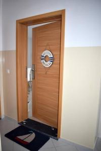 a wooden door with a clock on it at Modern - Luxury Rooftop 2 Bedroom 500 m from Beach in Santa Maria