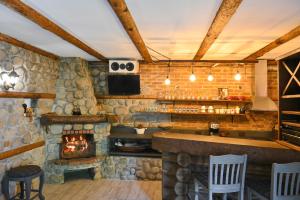 a bar in a restaurant with a stone fireplace at Klecherova House in Bansko