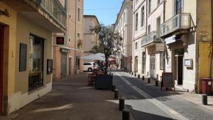 an empty street in a city with buildings at Studio Nîmes Centre in Nîmes +4 photos