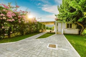 a driveway leading to a house with a garden at Koulouris Apartments & Studios in Kalyves