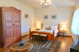 a bedroom with a bed and two tables in a room at Klecherova House in Bansko