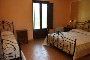 Postel nebo postele na pokoji v ubytování Agriturismo La Gemma del Parco