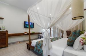 a bedroom with a bed with a canopy at Bayon Modern Residence in Siem Reap