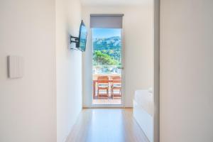 A television and/or entertainment centre at Terrazza Sella Del Diavolo - Vista Mare - WiFi AC