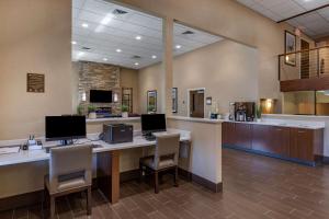a lobby with a desk with two computers and chairs at Comfort Inn Butte City Center I-15 - I-90 in Butte