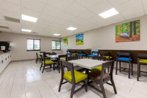 a dining room with tables and chairs at Clarion Pointe Tomah in Tomah