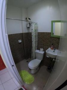 a bathroom with a toilet and a sink at Antwet Backpacker's Inn & Rooftop Bar in Dumaguete +46 photos
