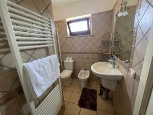 a small bathroom with a sink and a toilet at Cà del Giò in Massa +9 photos