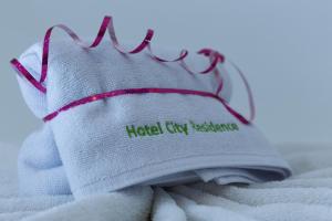 a pair of glasses sitting on top of a towel at Hotel City Residence in Vienna