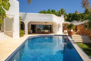 a swimming pool in the backyard of a house at EL PORTET - Managed by Almarina Villas in Benissa