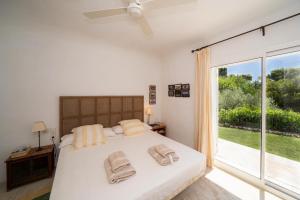 a bedroom with a bed and a large window at EL PORTET - Managed by Almarina Villas in Benissa +57 photos