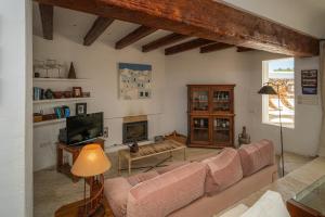 uma sala de estar com um sofá e uma televisão em EL PORTET - Managed by Almarina Villas em Benissa
