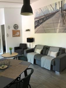 a living room with a couch and a table at Le Gîte au calme d'Aubignan 4 personnes, 1 chambre in Aubignan