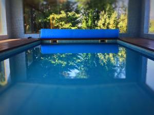a swimming pool with a blue bench and a window at Quinta Vale do Homem in Amares