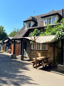 a wooden picnic table in front of a building at The Kings Arms Inn in Oakham