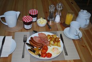 a plate of breakfast food on a wooden table at Hillcroft Luxury Bed & Breakfast in Fangfoss