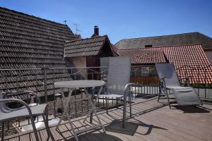a patio with chairs and a table on a deck at Landhotel Schwab in Schwarzach am Main