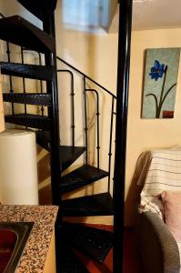 a black spiral staircase in a room with a sink at Casa del Águila del Valle in Riópar Viejo